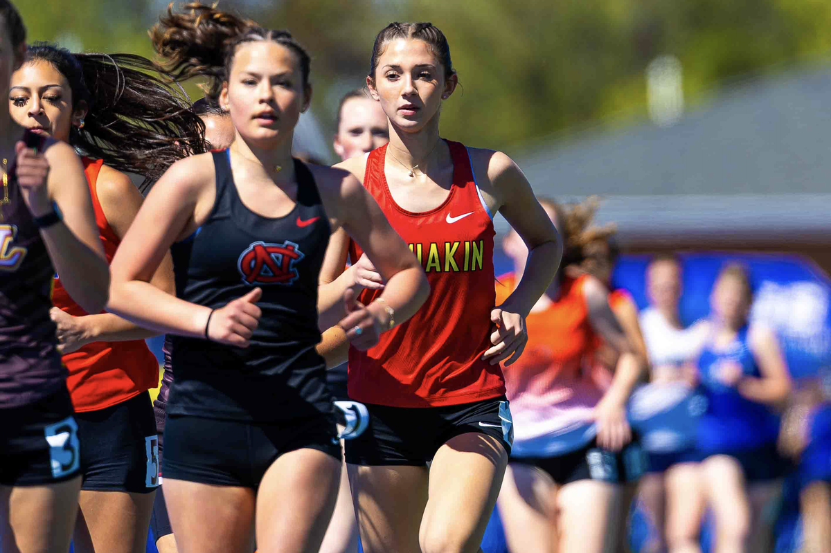 Kamiakin freshman Jaycee Jenkins, in red, won the girls 1600-meter varsity race Saturday, April 25, 2026, at the Legends Twilight Invitational in Walla Walla with a time of 5:03.52.