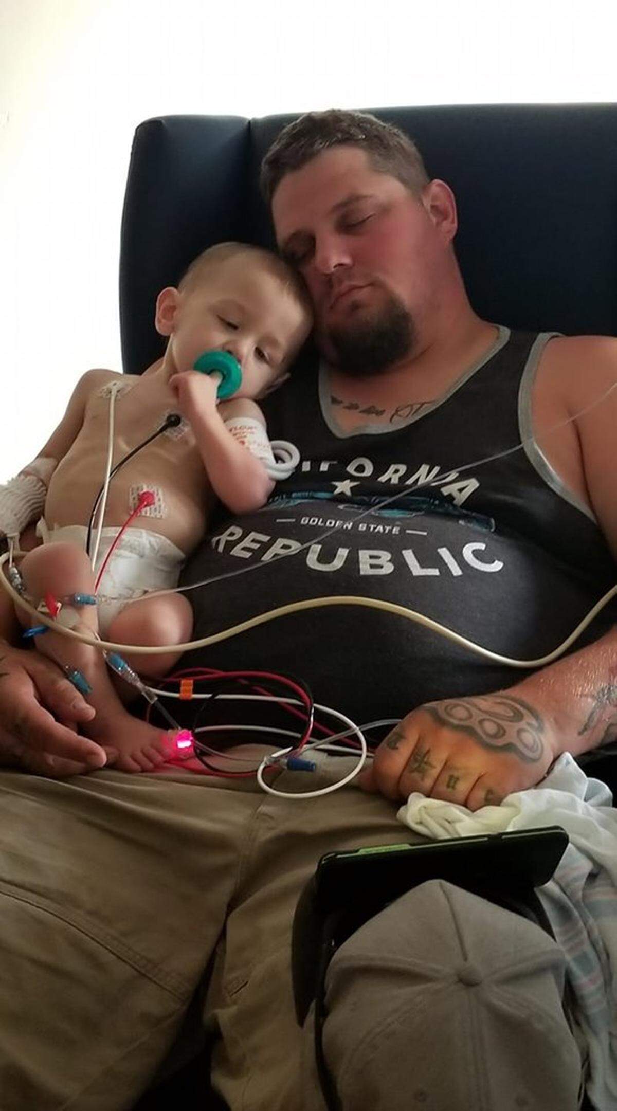 Jayce Marzyck, and his father, Jered Marzyck, of Richland, catch a nap together. Jayce is on a heart transplant waiting list.