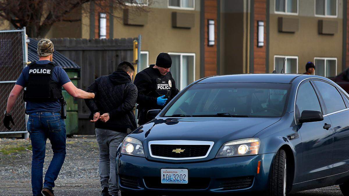 Kennewick police officers take a residential burglary suspect into custody at the Baymont Inn & Suites on West 27th Place in Kennewick in connection with a series of residential burglaries in the Tri-Cities region.
