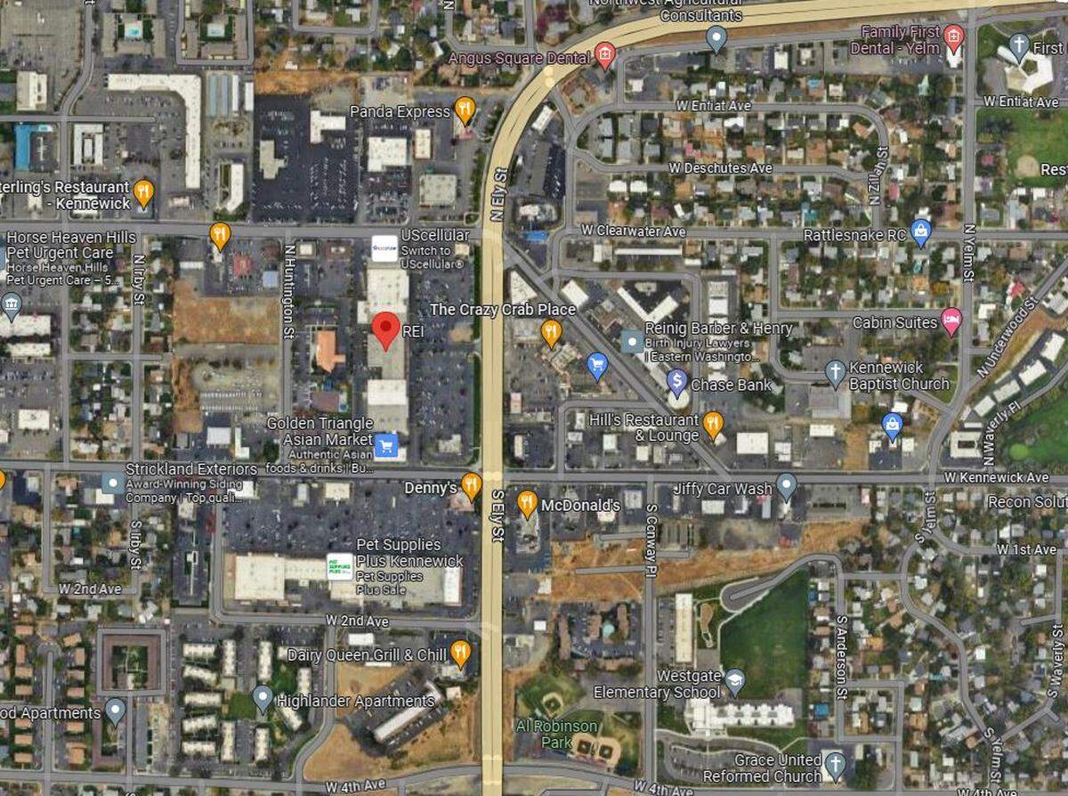 A man is accused of pushing down a woman and robbing her outside of a Kennewick shopping plaza.