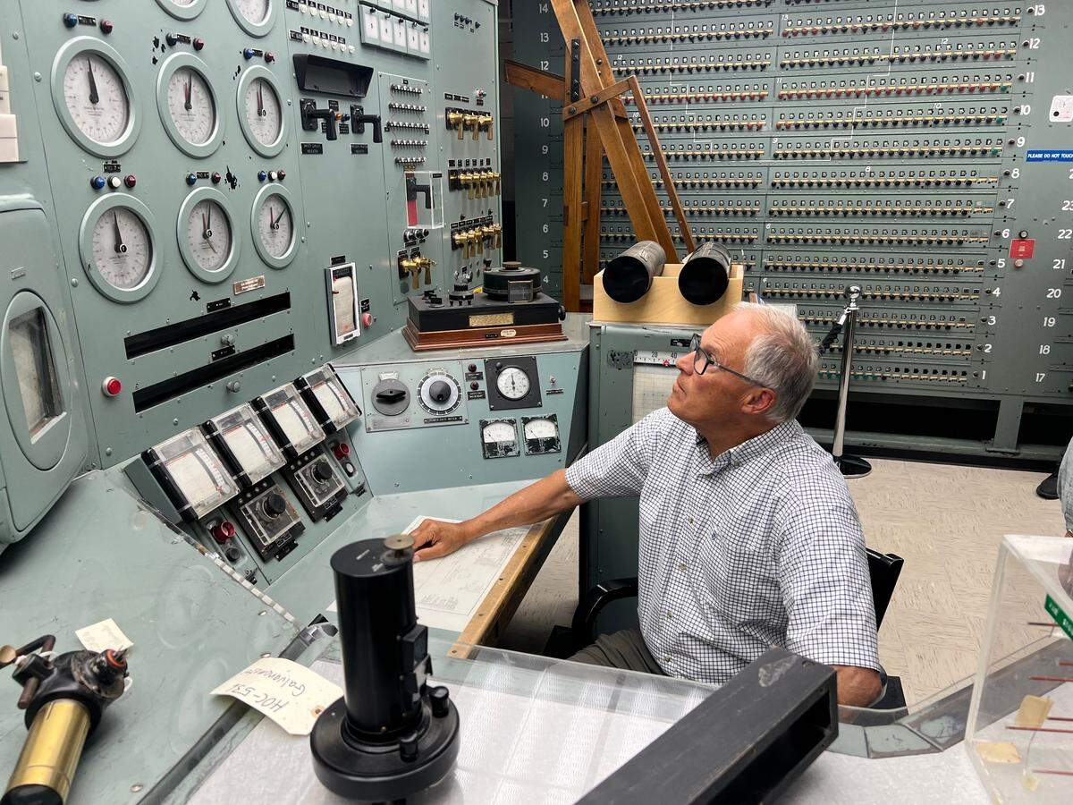 Washington Gov. Jay Inslee sits at the controls for Hanford’s historic B Reactor on Friday, July 12, 2024. It was his first look inside the reactor, part of the Manhattan Project National Historical Park.