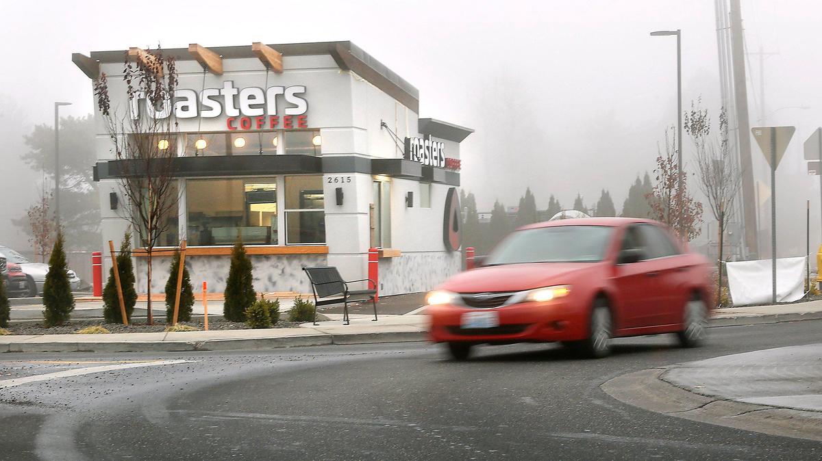 Traffic navigates the roundabout at West 27th Avenue and South Vancouver Street in Kennewick past the most recent Roasters Coffee to open. A new Richland Roasters opens Dec. 13.