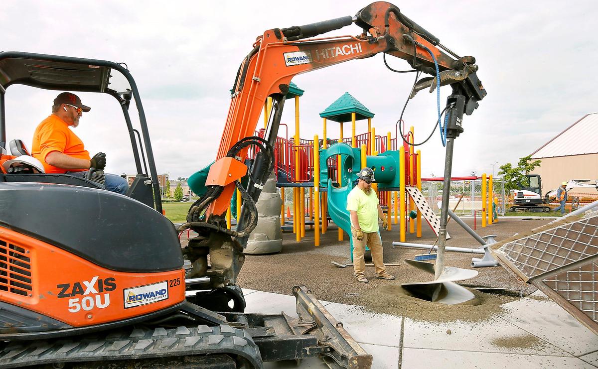 Workers bore footing holes for a new 2,028-square-foot shade awning being installed over the Southridge Sports & Events Complex playground. The complex will soon have an electronic readerboard in a deal between Numerica Credit Union and the city of Kennewick.