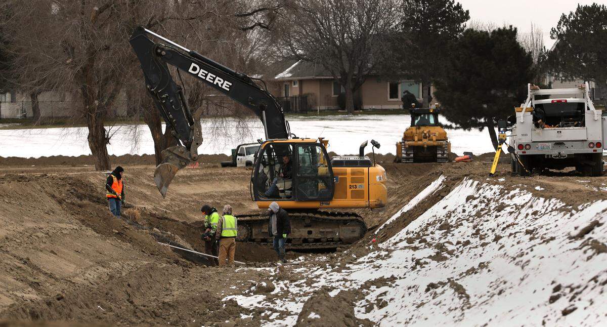 Crews from the Kennewick Irrigation District work in the empty irrigation canal through the Canyon Lakes Golf Course in Kennewick as part of an off-season improvement project of the water delivery system.