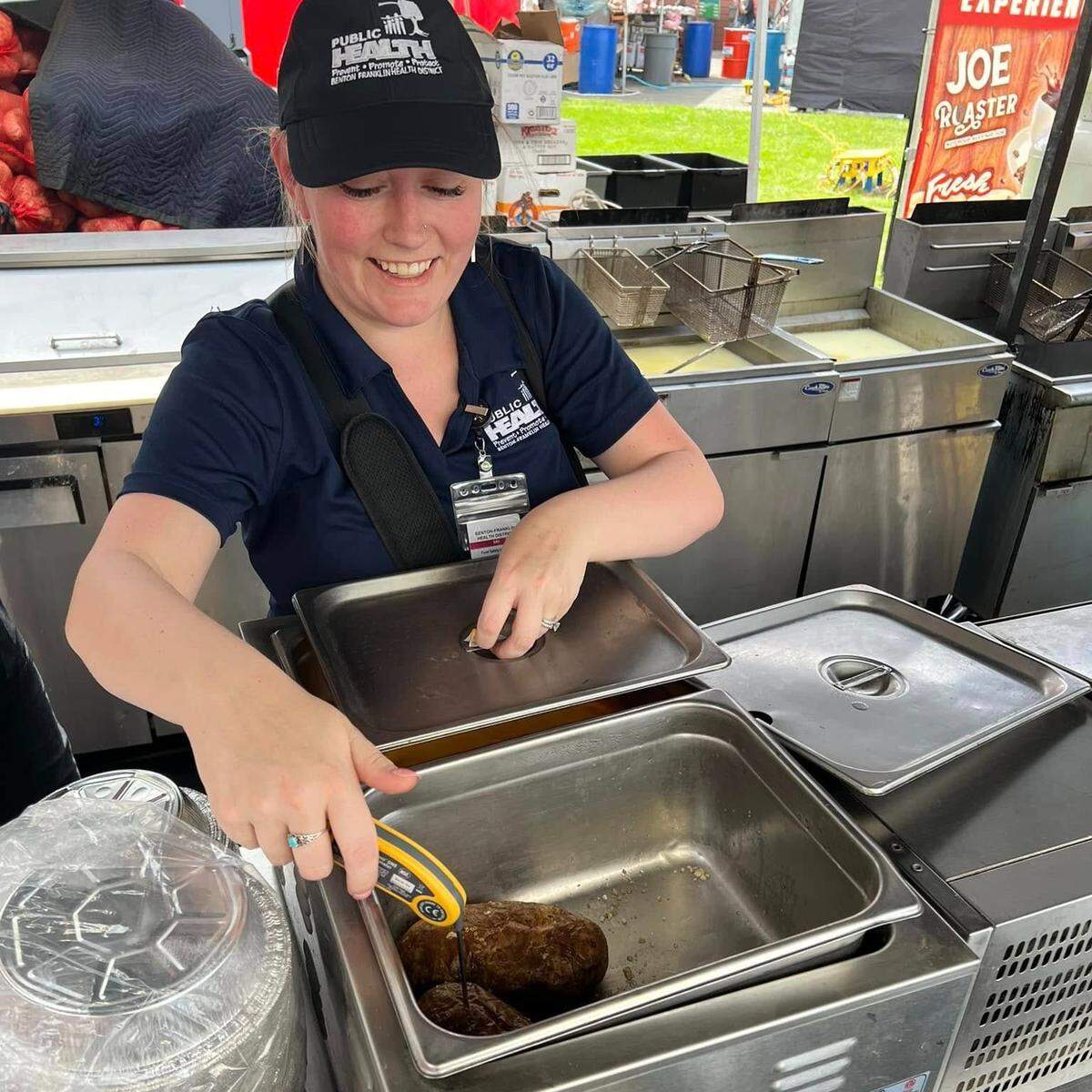 A Benton Franklin Health District food safety inspector checks the temperature of food.