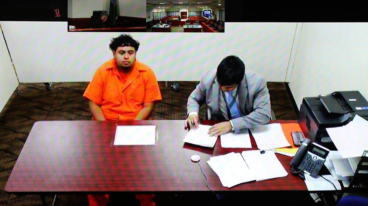 Shooting suspect Brian Armando Panduro-Valenzuela sits near provisional public defense lawyer Michael Anthoni Nguyen Wednesday during his preliminary hearing using a video link from jail in Franklin County Superior Court in Pasco.