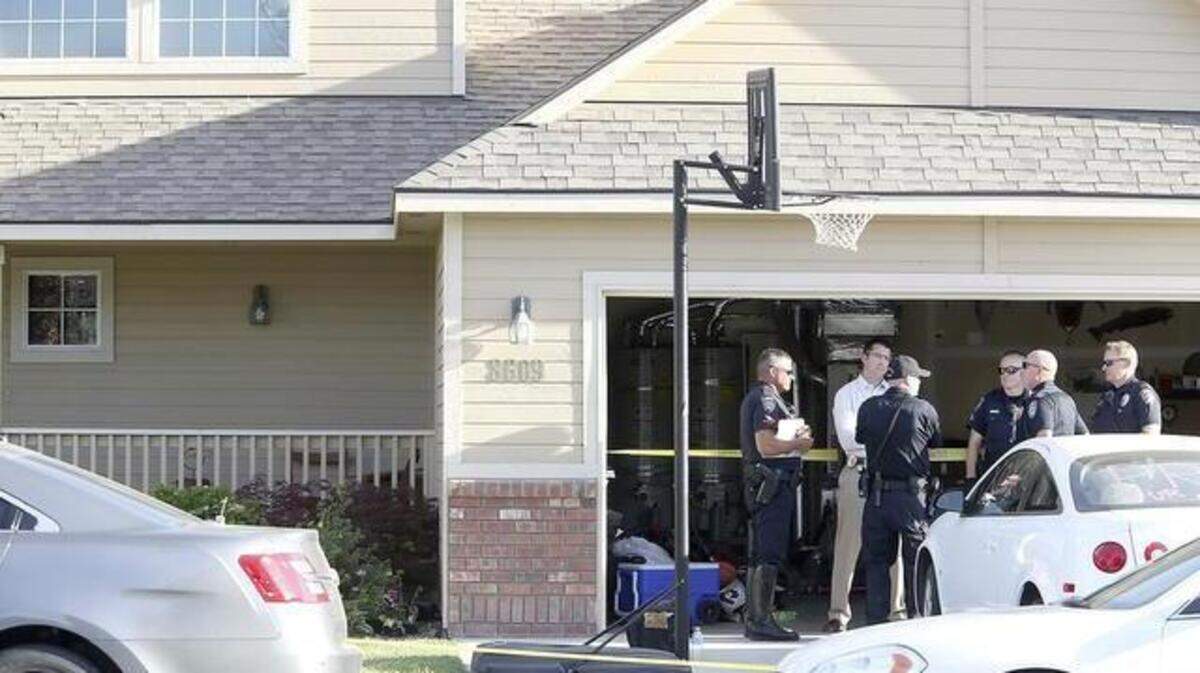 Kennewick police officers stand outside a Hansen Park home in June after reports of two children being found dead inside. Investigators ruled their deaths a murder-suicide.