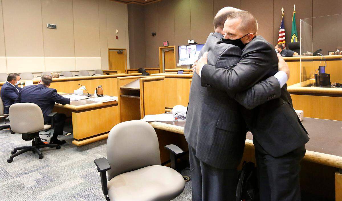 Sgt. Jason Erickson hugs attorney Alan Harvey after Judge M. Scott Wolfram ruled on a recall petition brought forth by Erickson against Benton County Sheriff Jerry Hatcher.
