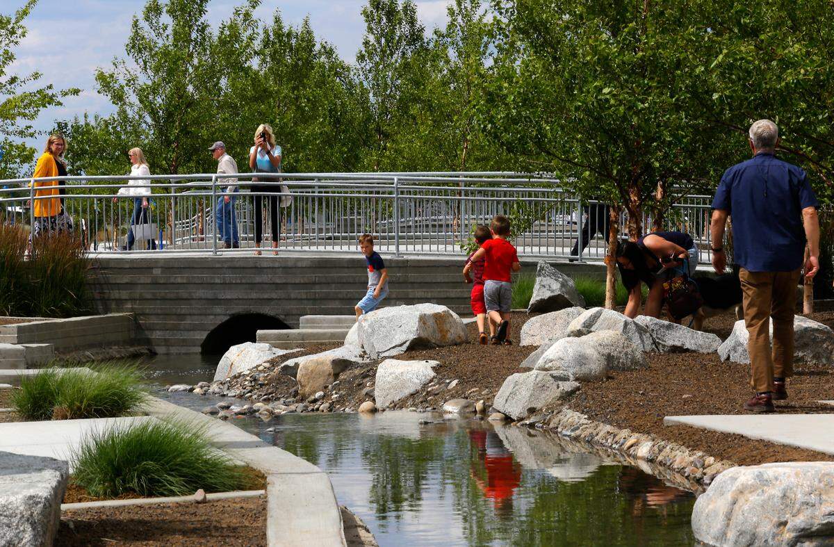 People attending the grand opening event for the Vista Field phase one site improvements check out the water features that are centerpiece of the first 20 acres of the west Kennewick project to open for private development.
