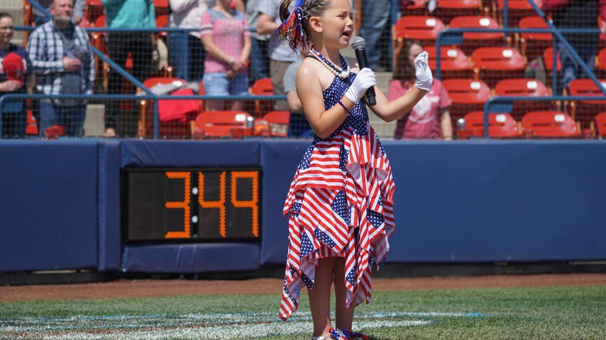 Kinsley Murray, 6, performs the national anthem at a sporting event.