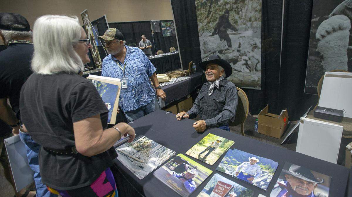 Sasquatch enthusiasts line up to meet Bob Gimilin, center, during the three-day International Bigfoot Conference & Film Festival at the Three Rivers Convention Center in Kennewick on Saturday. Gimilin is a cowboy who was asked by Roger Patterson in 1976 to help track Bigfoot in Northern California. Their famed footage shows the creature seeming to look back at the camera.