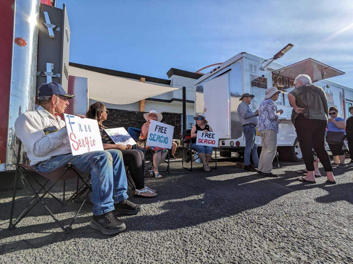 Picketers protest the immigration detention and arrest of Sergio Cerdio Gomez of Pasco during an eat-in at the family’s Kennewick food truck, Hibachi Explosion. 