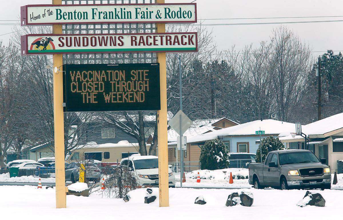An electronic message board reminds drivers on West 10th Avenue the COVID-19 vaccination drive-thru site at the Benton County Fairgrounds is temporarily closed due to a lack of vaccine doses because of severe winter weather across the nation.