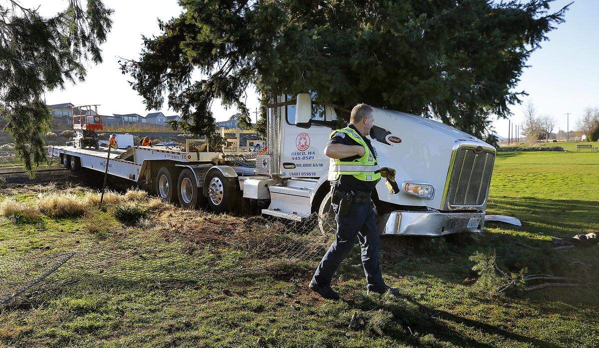 Kevin Osborn, a commercial vehicle enforcement trooper with the Washington State Patrol, investigates the semi-truck crash on Highway 240 Wednesday afternoon in Kennewick. 