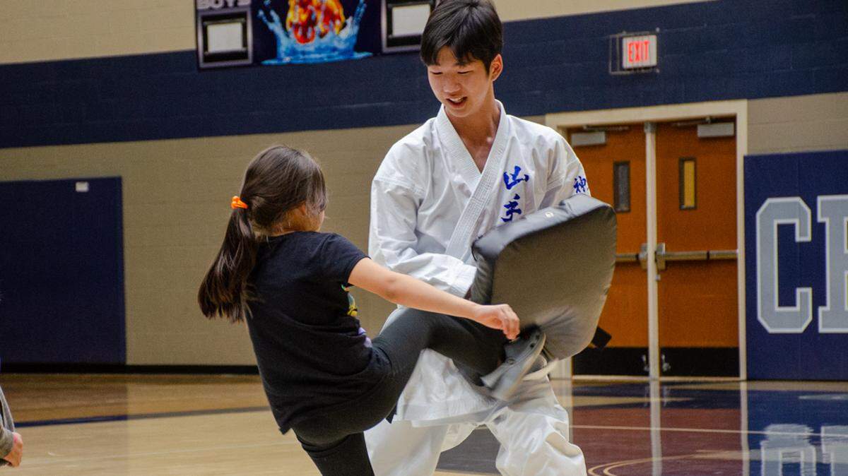 Yamate exchange student Yuuki Futami lets attendees of International Night try their best karate kick during a demonstration in front of a packed Chiawana High School gymnasium.