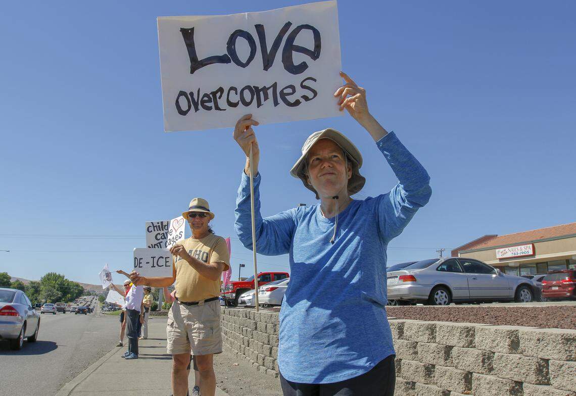 More than 50 members of Kennewick's Community Unitarian Universalist Church and other Tri-Citians gather Saturday along Highway 395 near Kennewick Avenue to protest federal policy that separates children from their parents at the southern border