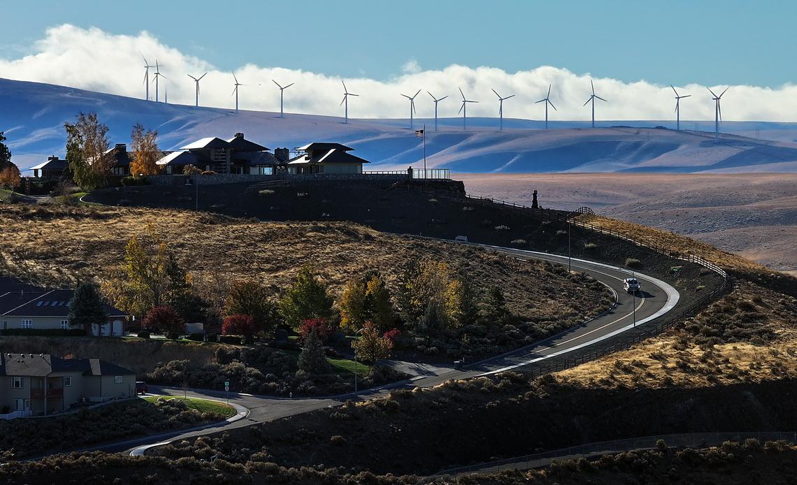 Clouds glide past the wind turbines on the hills south of Kennewick.