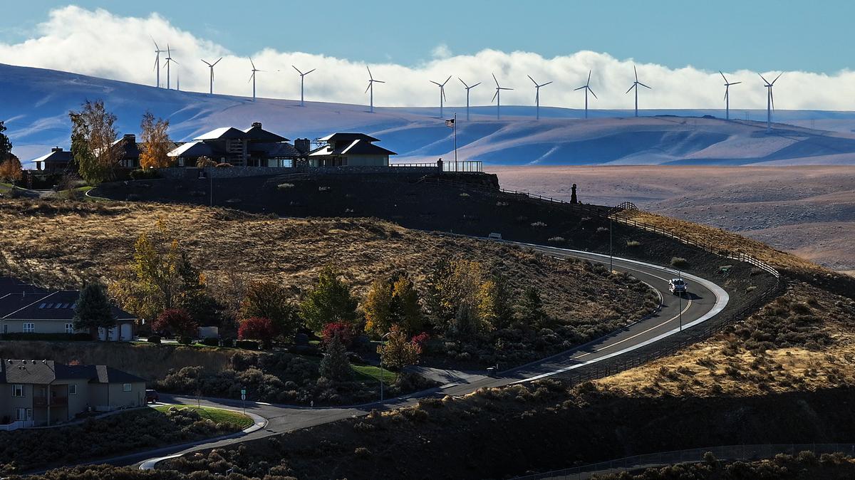 Clouds glide past the wind turbines on the hills south of Kennewick.