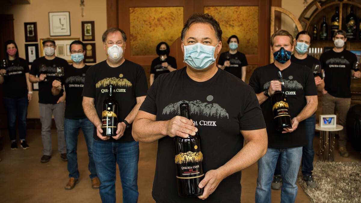 Quilceda Creek Vintners, one of Washington state’s oldest family-owned wineries, donated $365,000 to the Restaurant Employee Relief Fund. Holding 3-liter bottles from left to right are Bill Reith, CFO; Paul Golitzin, President/director of winemaking, center, and general manager Scott Lloyd. On the left (from left to right) is MacKenna Bean, Northwest sales/tour and tastings; Alex Stewart, winemaker/enologist/production manager, and Lawrence Stewart, director of member relations. Behind Lloyd, on the right, is assistant winemaker Hal Iverson and behind Iverson is assistant winemaker Jesse Schmidt. In the far back, between Golitzin and Lloyd, is member relations liaison Owen Mayo.