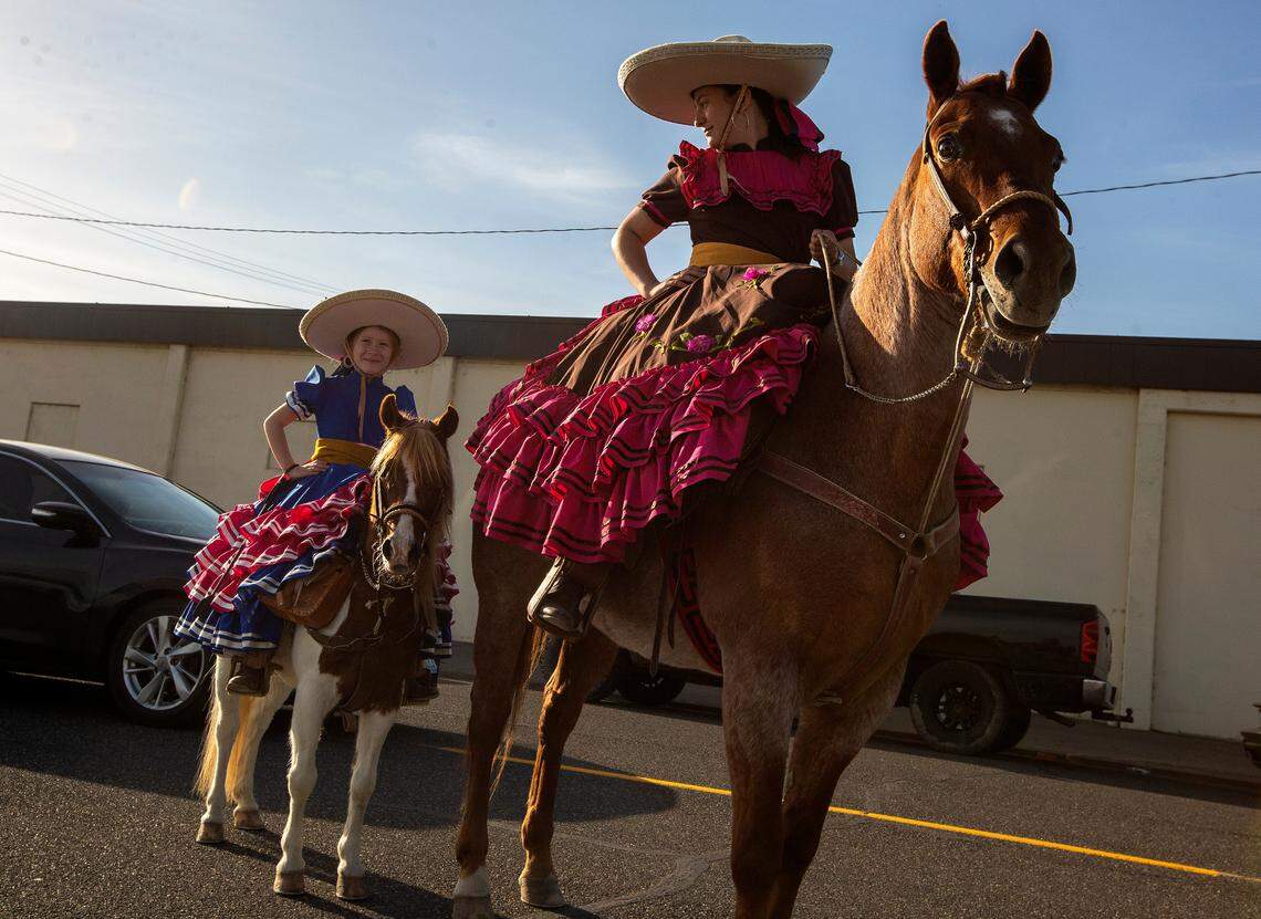 Sisters Gardenia, 6, left, and Gema Torres Sepulveda, 13, ride their horses to Pasco’s Cinco de Mayo parade on Friday. Gardenia and Gema are in the parade with their father, Marino Torres, who is a charro, which is a Mexican horseman. Festivities will continue Saturday.