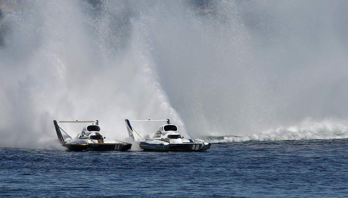 Corey Peabody in the U-9 Miss Beacon Plumbing and Andrew Tate in the U-91 Goodman Real Estate unlimited hydroplane are deck-to-deck as they race in Heat 3A Sunday on the Columbia River. Race officials gave Peabody a penalty for veering out of his lane and Tate was disqualified for a fuel violation.