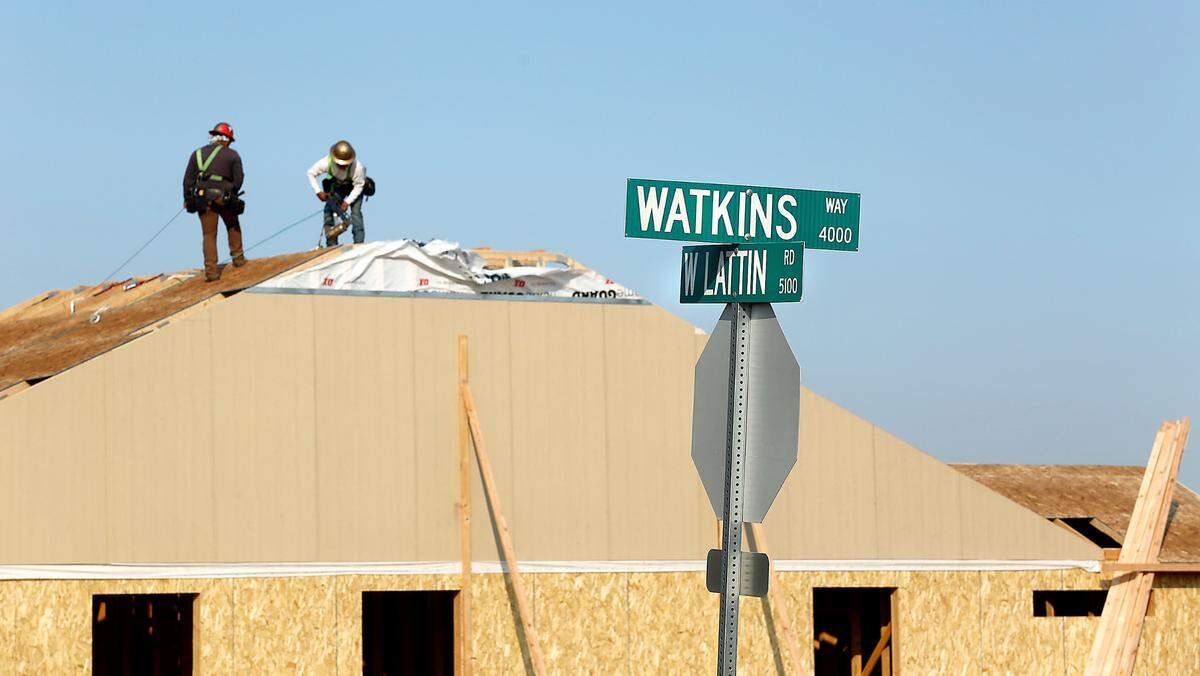 A construction crew works on the roof of a new home being built in Hayden Homes’ new development called Hazelwood Heights off Watkins Way between West Lattin and Keene Roads in West Richland.
