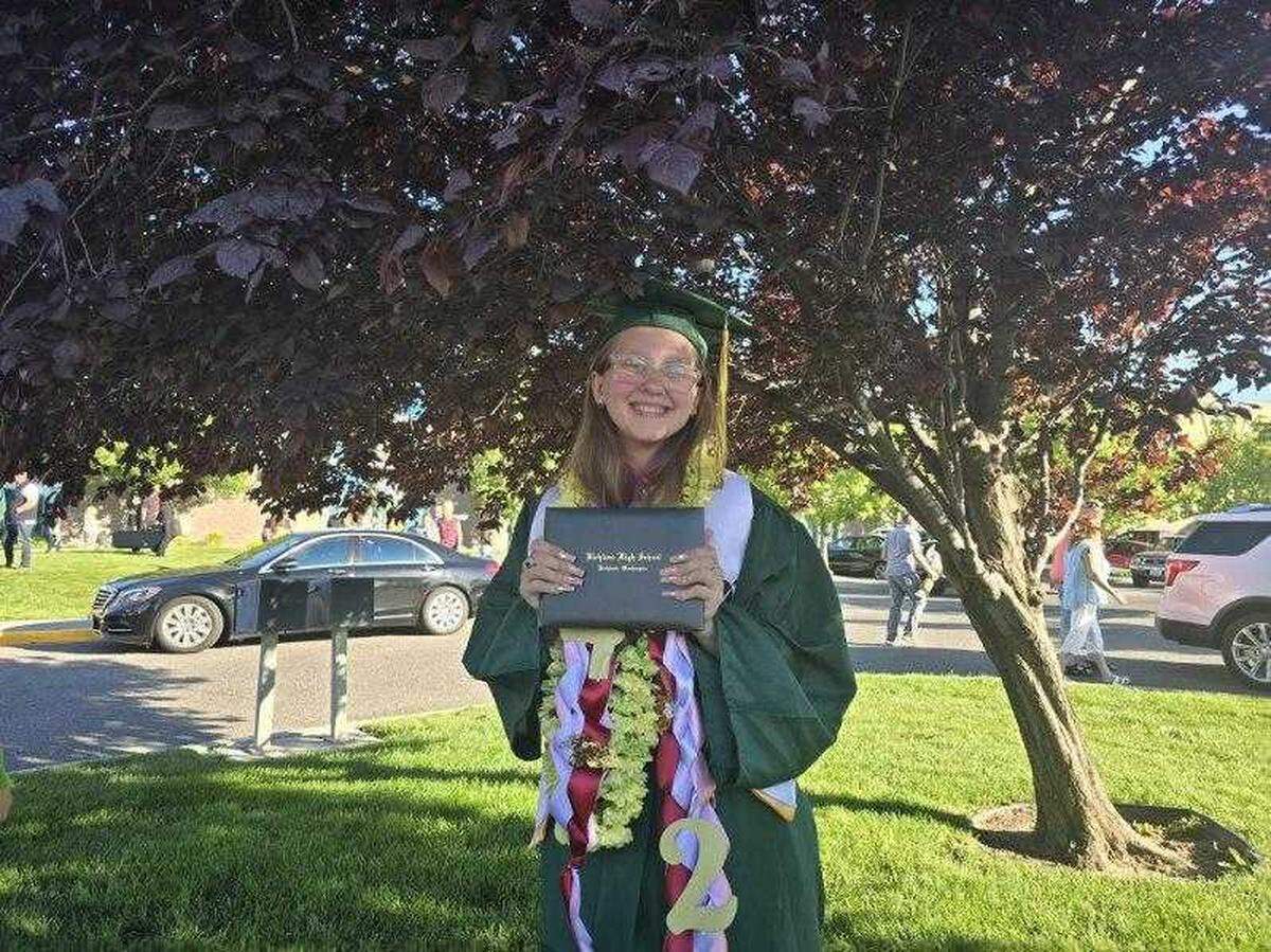 Richland High School graduate Erika Meneni poses for a photo Friday, June 7, after receiving her diploma during a commencement ceremony. Meneni overcame homelessness, academic apathy and learning frustrations during the COVID pandemic to earn her diploma.