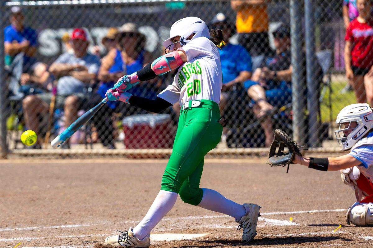 Richland sophomore catcher Olivia Lopez, No. 20, drives a line shot to center field against the Eastmont Wildcats during the opening round of the 4A State Fastpitch Softball Championships on Friday in Richland. Richland defeated Eastmont to advance to Friday evening’s quarterfinal matchup against the Rogers Rams of Puyallup. The winner advances to the semifinal round on Saturday morning