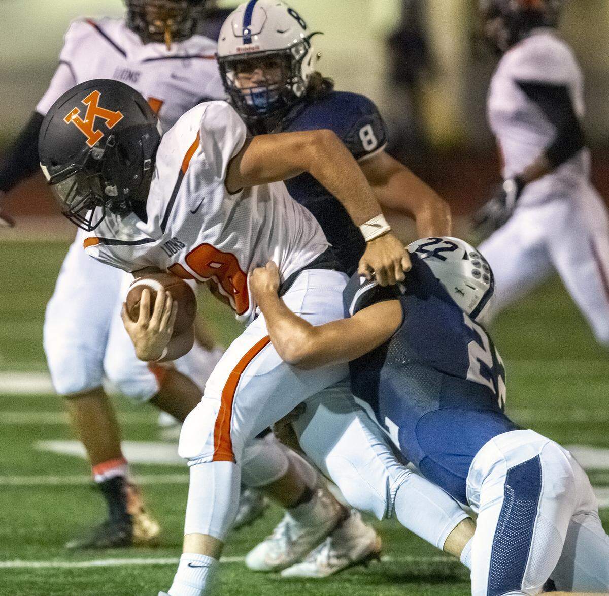 Kennewick’s Myles Mayovsky (18) is tackled by Chiawana’s Riley Cissne (22) during a Mid-Columbia Conference high school football game at Edgar Brown Stadium in Pasco on Friday. Chiawana won 37-0.