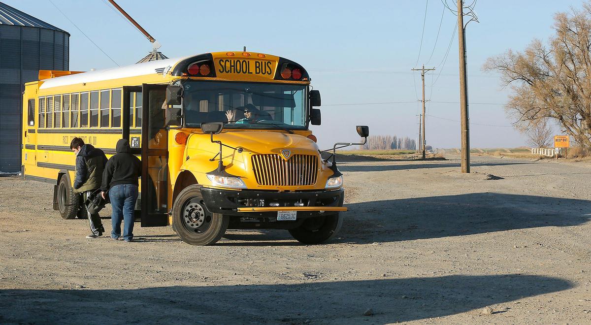 The mother of a Pasco high school student greets her son at the school bus where it turns around in a dirt lot near a grain silo. She drives three miles on the gravel private road up to six times each school day to pick up and drop off her children because school buses can’t drive on the unmaintained private road. Watch a video at: tricityherald.com/video