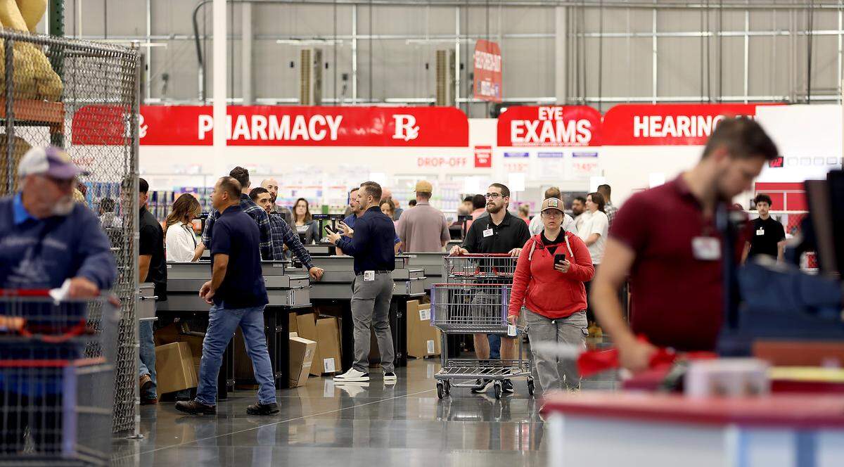 Customer and employees near the checkouts after the doors opened following a brief grand opening ceremony Friday morning for the new Costco Wholesale store at 3125 Queensgate Dr. in Richland.