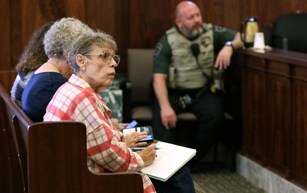 Nancy Lenhart, widow of stabbing victim Richard Lenhart, takes notes during a pre-trial hearing for Joshua D. Davis on Monday morning in Franklin County Superior Court in Pasco. 