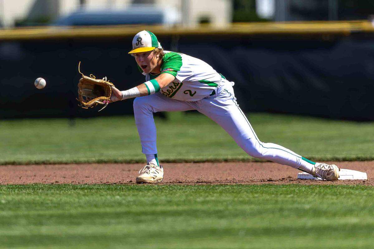 Richland junior second baseman Jackson Woodard stretches for a throw during opening-round play against the Skyline Spartans at the WIAA 4A State Baseball Championships Saturday at Bomber Bowl in Richland.