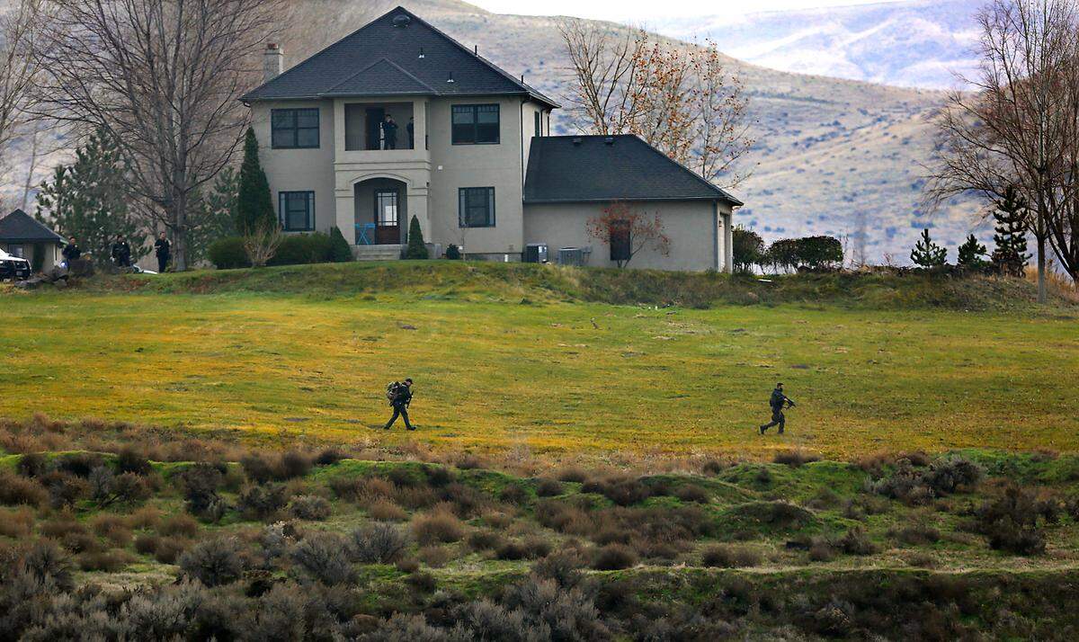 Members of the Tri-Cities Regional SWAT team move towards a ravine after detectives encountered Kennewick murder suspect Adam P. Klei just south of East 44th Avenue and South Gum Street in Kennewick.