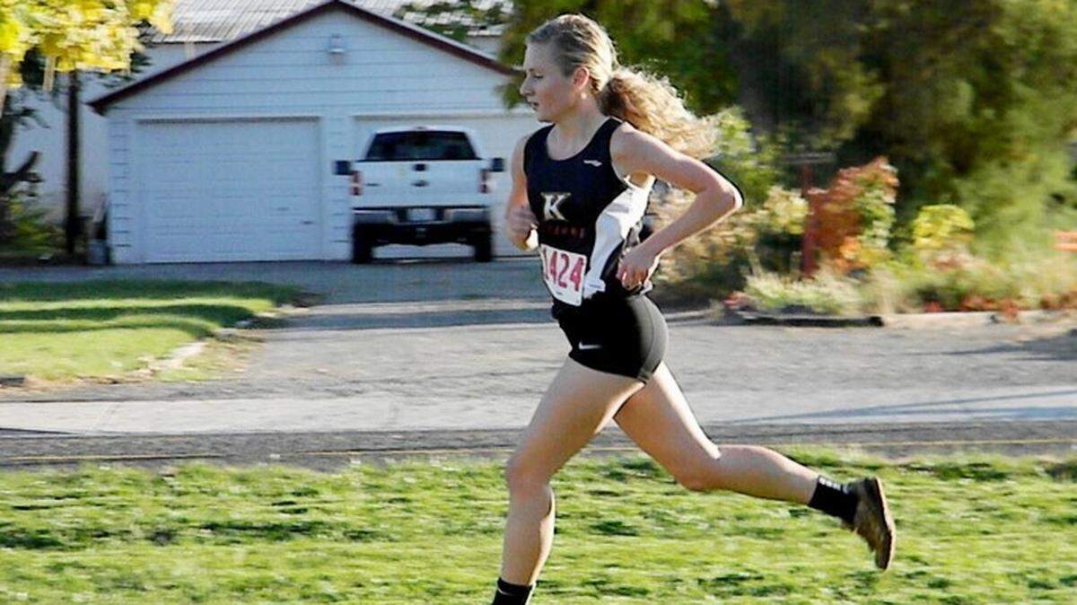 Jori Perrins runs Kamiakin High School cross-country through a neighborhood.   In her free time, she enjoys running on the scenic natural trails.
