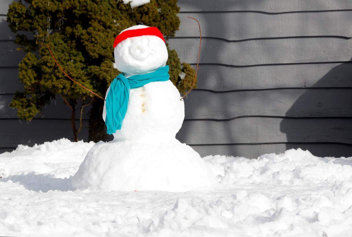 A snowman wearing a colorful scarf and headband sits in the front yard of a home Wednesday morning on West Fourth Avenue in Kennewick. The National Weather Service has increased its prediction for the chance of snow Thursday evening in the Tri-Cities.