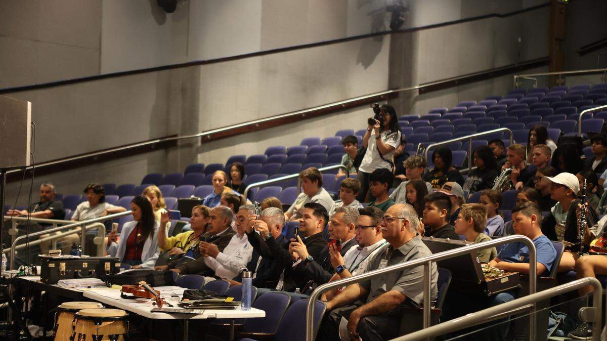 A delegation of educators from Colima, Mexico watch Pasco High School’s band perform.