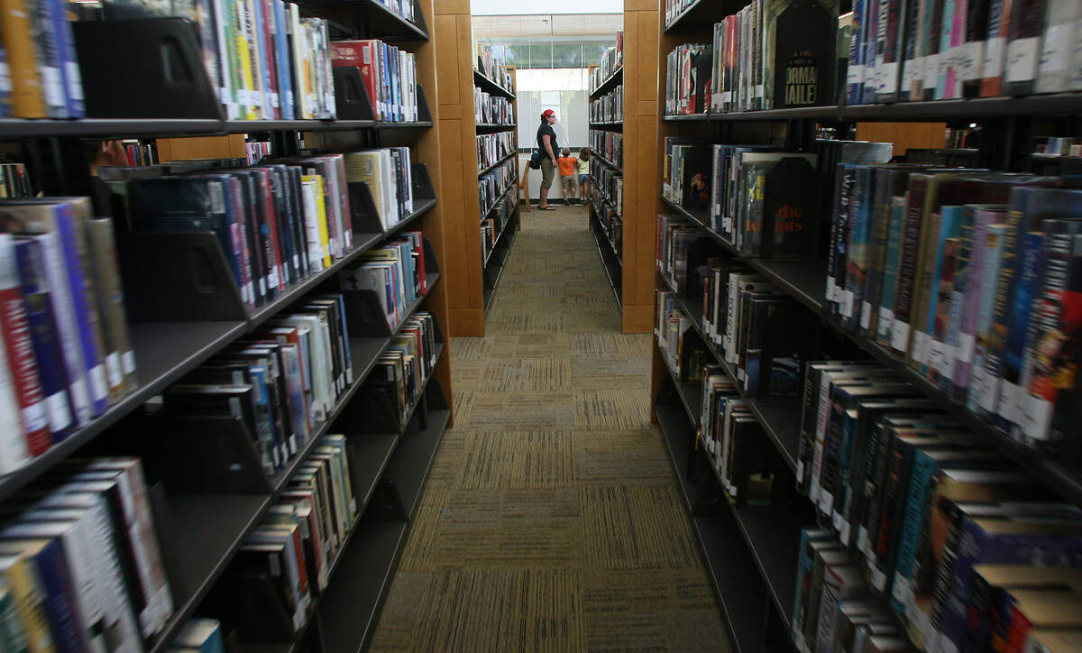 Patrons search for books at the Richland Public Library at 955 Northgate Drive in Richland.
