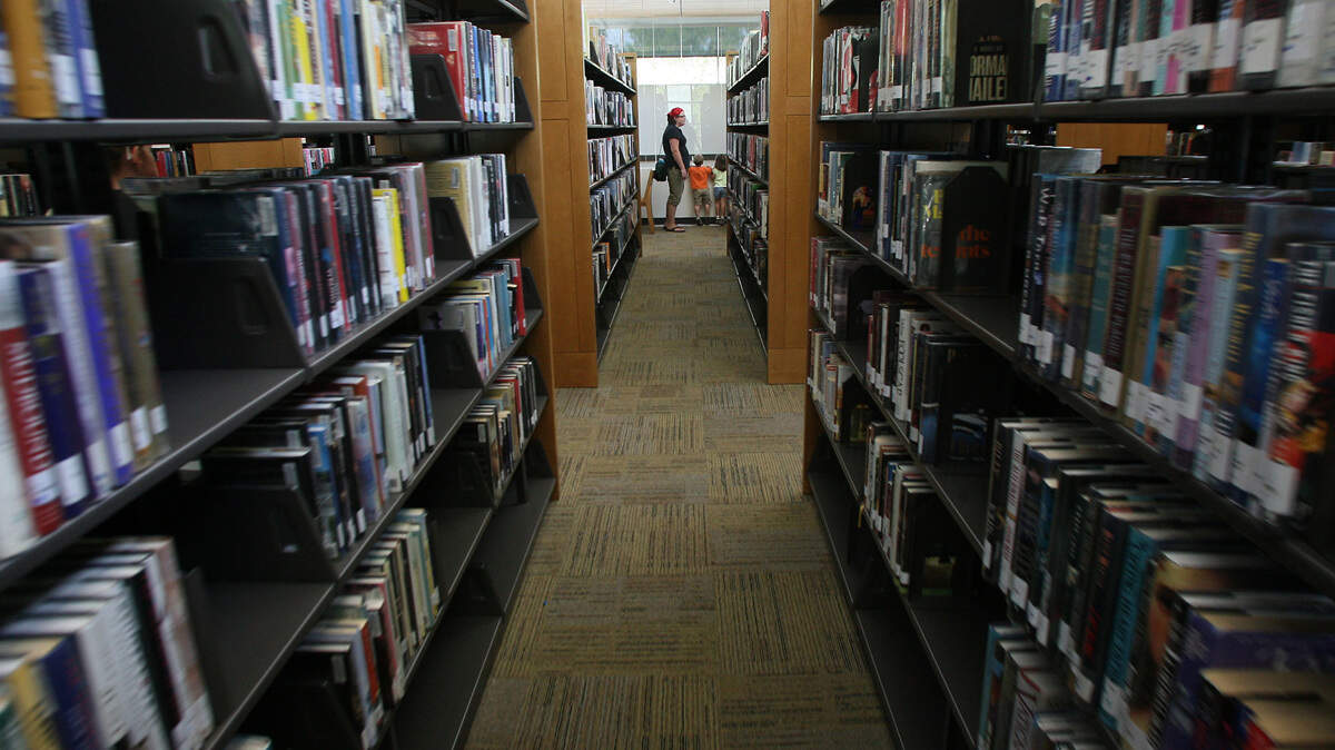 Patrons search for books at the Richland Public Library at 955 Northgate Drive in Richland.