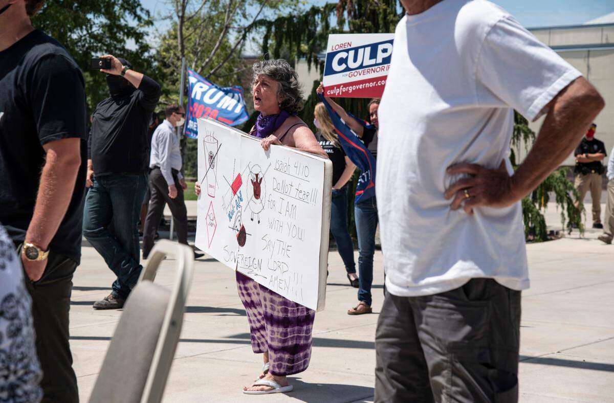 Protesters held signs and a few shouted during Gov. Jay Inslee’s media briefing at Columbia Basic College in the Tri-Cities on Tuesday. During the press conference, which was moved inside due to safety and noise concerns, Inslee addressed the need to wear masks if Tri-Cities businesses are to open back up anytime soon.