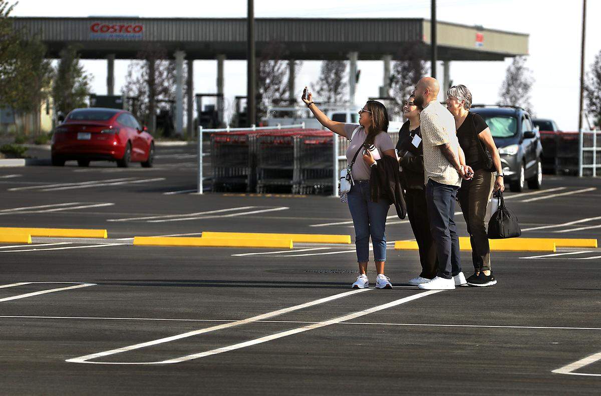 A small group of employees pause for a selfie in the parking lot before reporting inside the new Costco Wholesale store at 3125 Queensgate Drive in Richland. The new location is scheduled to open at 8 a.m. on August 8.