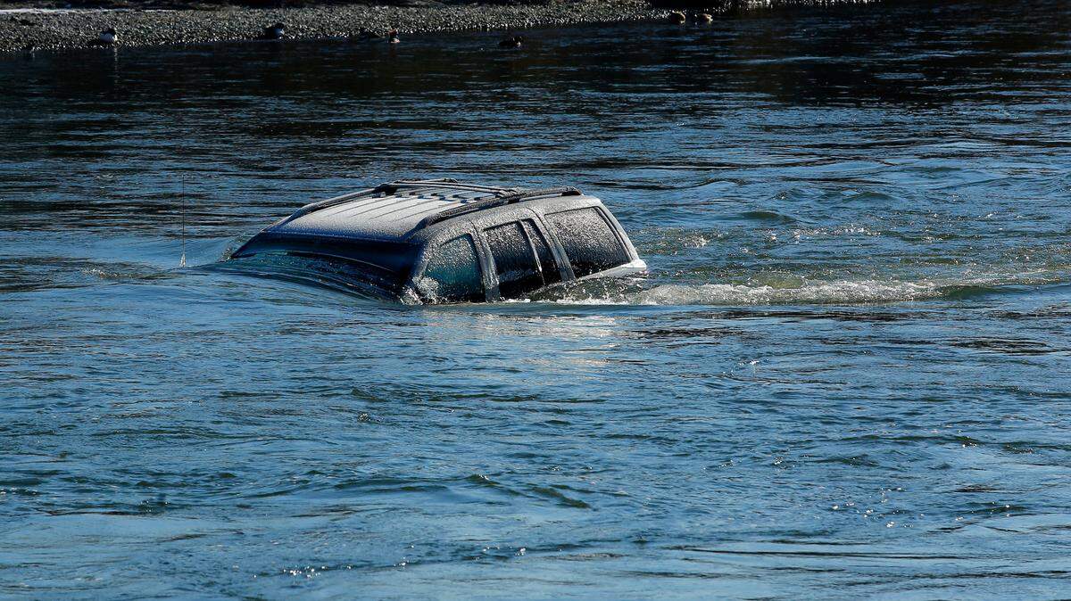 A Jeep SUV is covered in ice after being submerged in the Yakima River just downriver of the Van Giesen Street bridge near West Richland. Police officials are aware of the vehicle and say it will be several weeks before it can be safely removed.