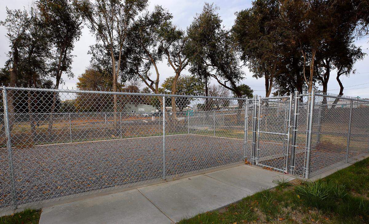 The old building of the Tri-Cities Animal Shelter is visisble behind the fenced dog exercise area adjacent to the agency’s newly constructed facility.