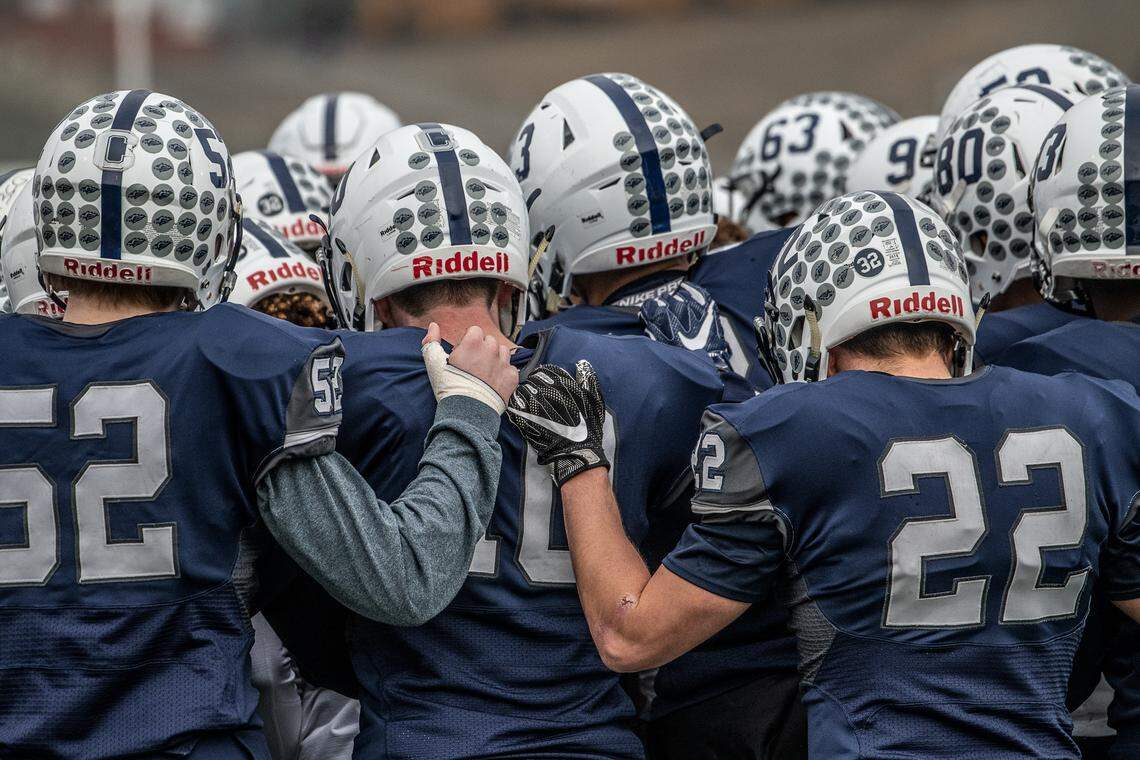 Chiawana High’s football players huddle prior to the start of Saturday’s game against Mount Si in Pasco.