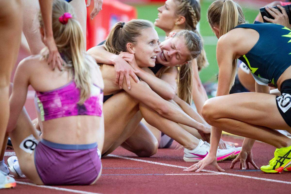 Allie Ostrander, center right, embraces Marisa Howard at the finish line of the women's 3,000 meter steeplechase during day seven of the U.S. Olympic Track & Field Trials Thursday, June 27, 2024, at Hayward Field in Eugene, Ore.