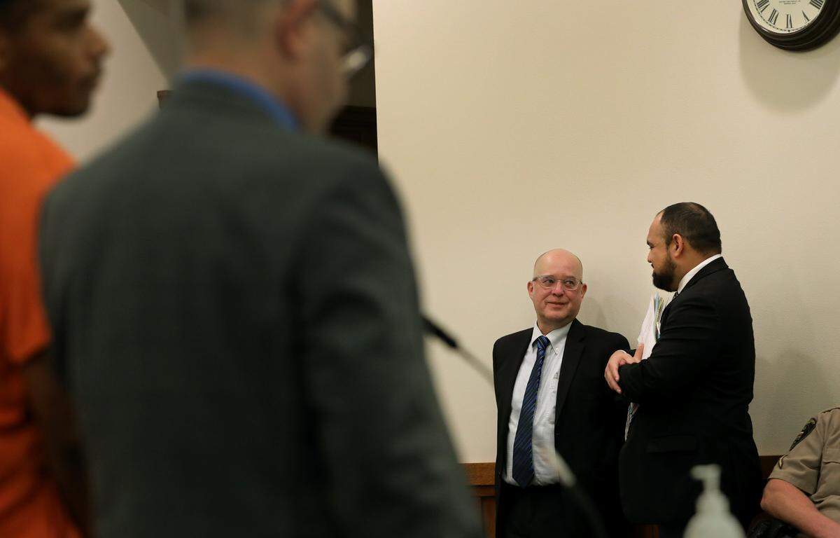 Assistant Attorney General Scott Halloran, left, talks with defense attorney David Betancourt Tuesday monring in Franklin County Superior Court in Pasco.