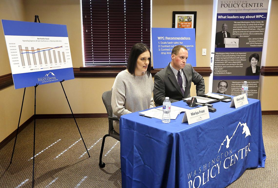 Mariya Frost, left, and Chris Cargill, with the Washington Policy Center, hold a news conference Tuesday in Kennewick to release their research findings on Ben Franklin Transit. The organization says the transit agency has increased spending as ridership has declined. Watch a video at: tricityherlad.com/video