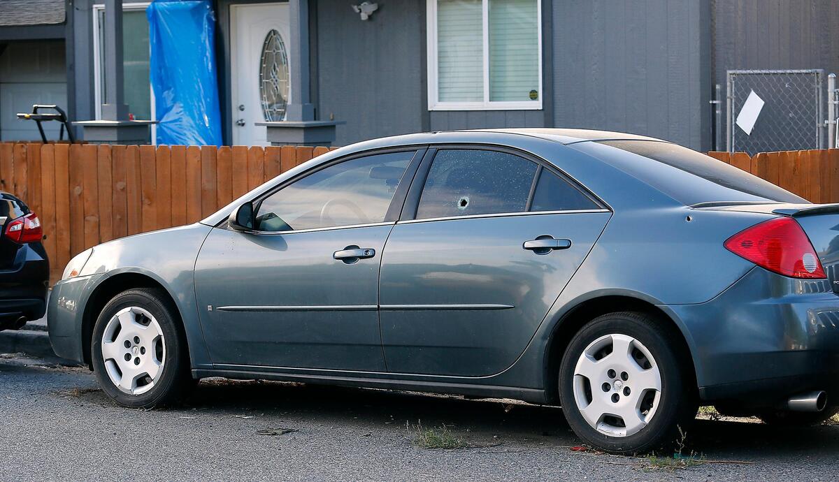 This Pontiac four-door sedan wasstruck by bullets at least three times during a Sept. 22 shooting in the 500 block of East Eighth Avenue in Kennewick. Investigators found shell casings and bullet holes in several vehicles and houses.