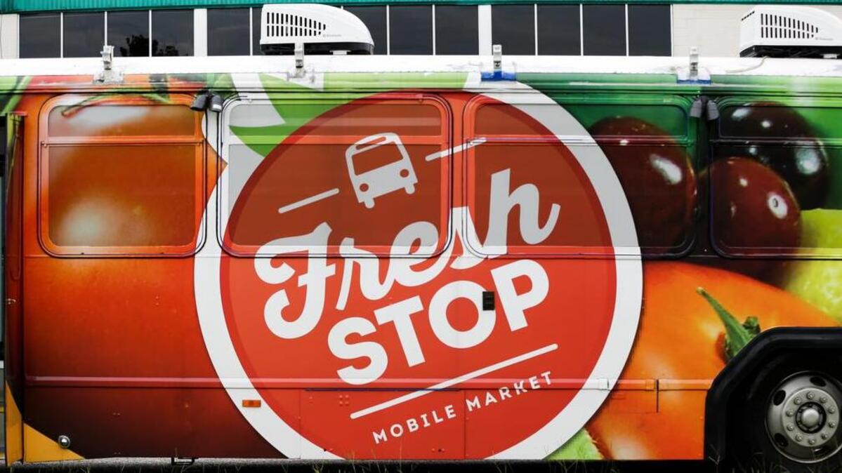 The side of the Fresh Stop mobile market bus is seen during a stop in Eatonville, Fla.