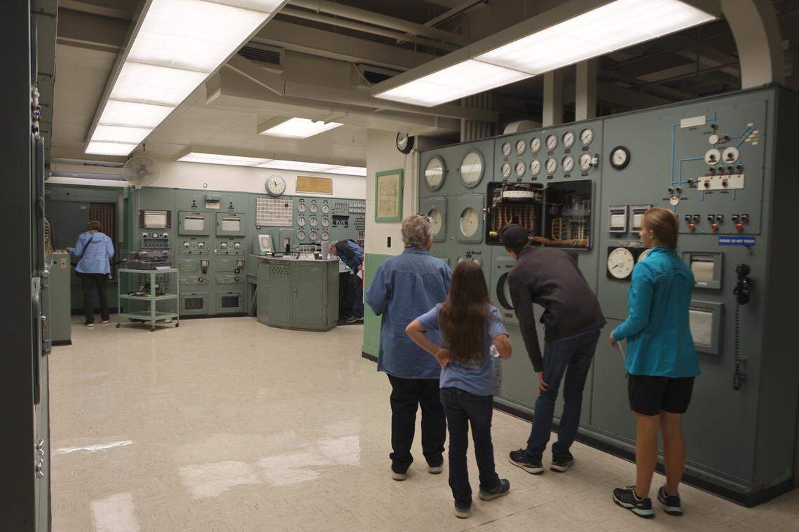 A small group walks into the control room at the B Reactor.
